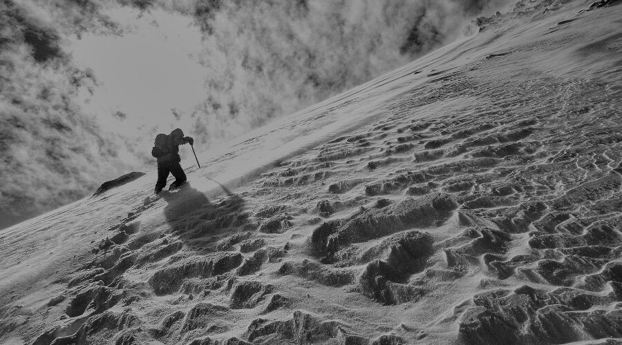 Man in the mountains in deep snow