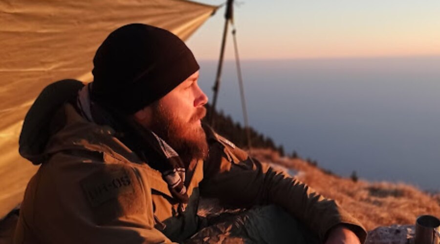 Man watching sunset in Snugpak Contact Fleece Beanie. 