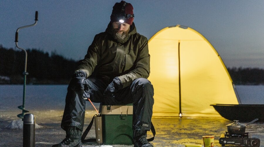 Man camping wearing a winter clothes 