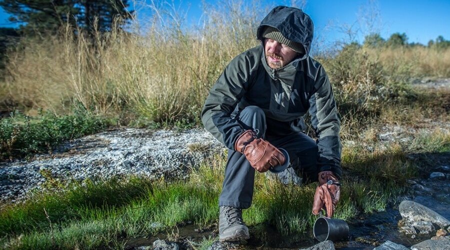 Man in gloves collecting water 