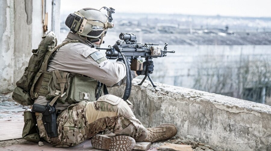 Armed man with helmet and ballistic protection. 