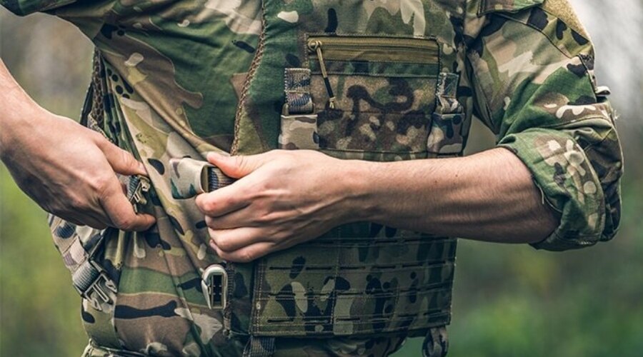 Man fastening his plate carrier 