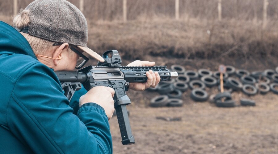 man in a cap shooting at a target