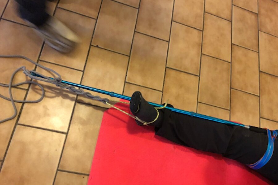 A leg fixed with a trekking pole.