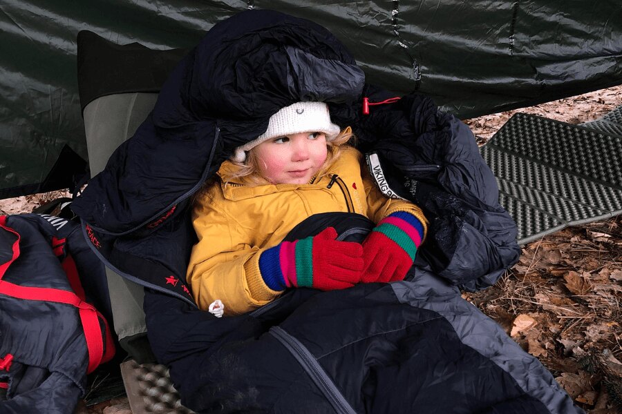 a child in a sleeping bag