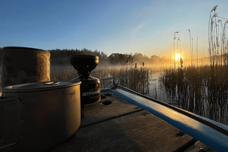 Jetboil cooker and Keith dishes by the water in Estonia at sunrise