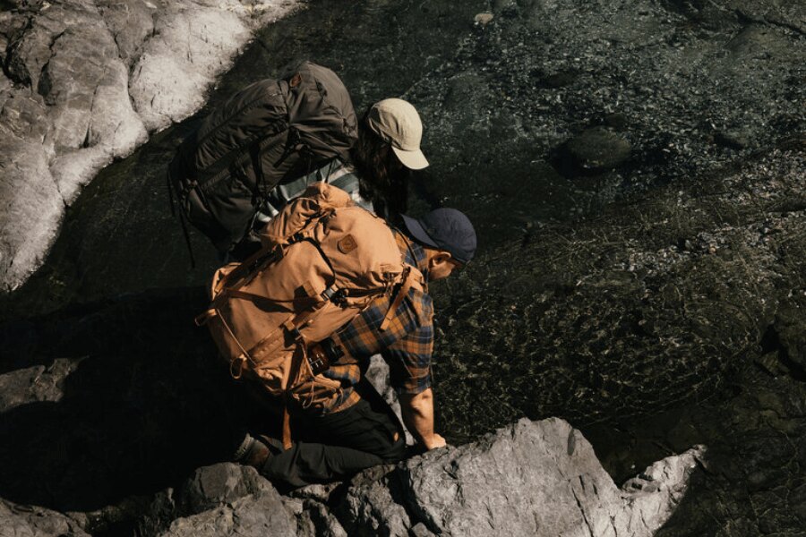 Men in the Fjällräven clothing at a river. Source: Fjällräven, Rigad.cz