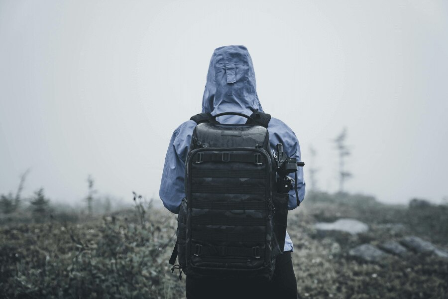 A person in a water resistant jacket in a frosty landscape. Source: https://www.pexels.com/cs-cz/foto/priroda-muz-kmeny-chytry-telefon-5048614/