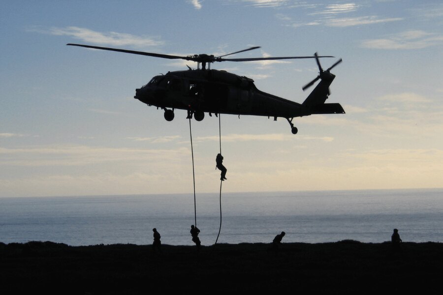 Rappelling from a helicopter during the Navy SEALs course. Source: Michal Ščepko and NSWC