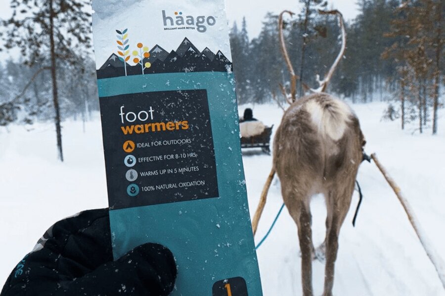 A package of Haago foot warmers in a winter countryside behind a reindeer yoke. Source: Rigad.com, Haago.com