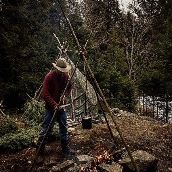 A man by the fire and his shelter